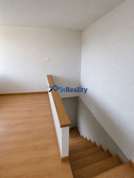 A floor with a wooden decor and stairs in a family house.