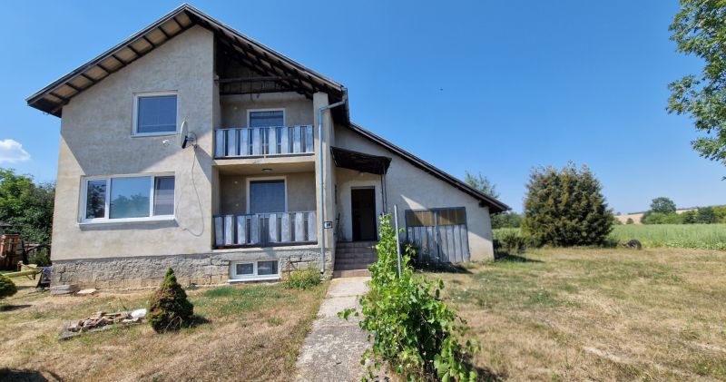 A family house on Biela Street in Kazimír, surrounded by a spacious garden and a blue sky.