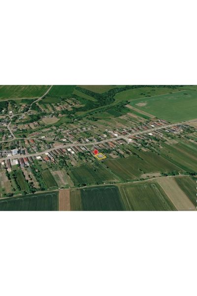 Aerial view of family houses in the village of Kazimír on Biela Street surrounded by fields.