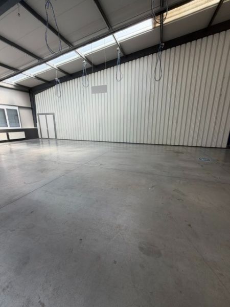 Spacious interior of warehouses and halls with high ceilings and concrete floors.