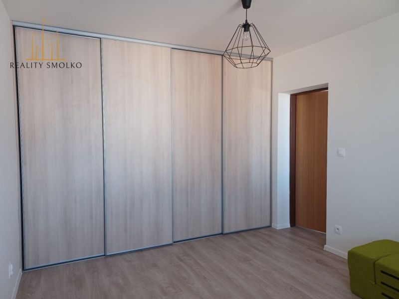 In the 2-room apartment, there is a built-in wardrobe and a floor with a wooden decor.