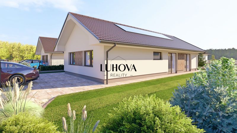 A family house in Tuchyňa with a sloped roof and a parking lot in front of the building.