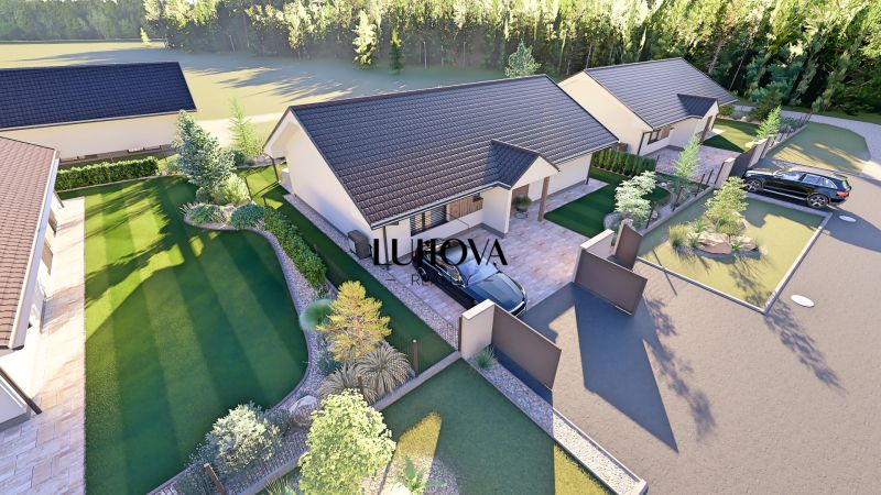 A family house in Tuchyňa in Tuchyňa with a lawn, terrace, and driveway.