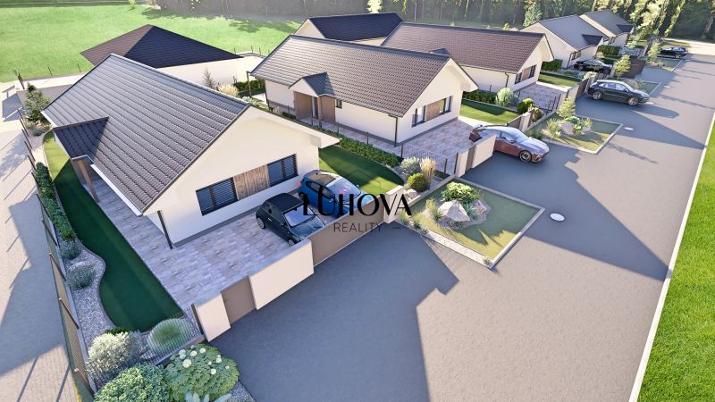 Family houses on the street in Tuchyňa with parking and gardens.