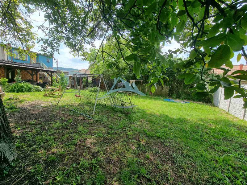The garden at the family house on Šípošova Street in Šahy with a swing and trees.