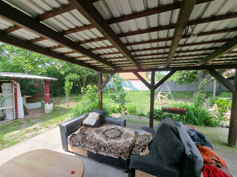 The veranda of a family house on Šípošova Street in Šahy with a sofa and a garden.