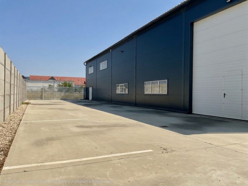 Warehouses and halls on Cementárenská Street in Stupava with paved areas and industrial gates.