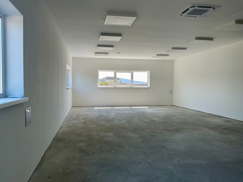 Spacious empty interior in warehouses and halls with large windows.
