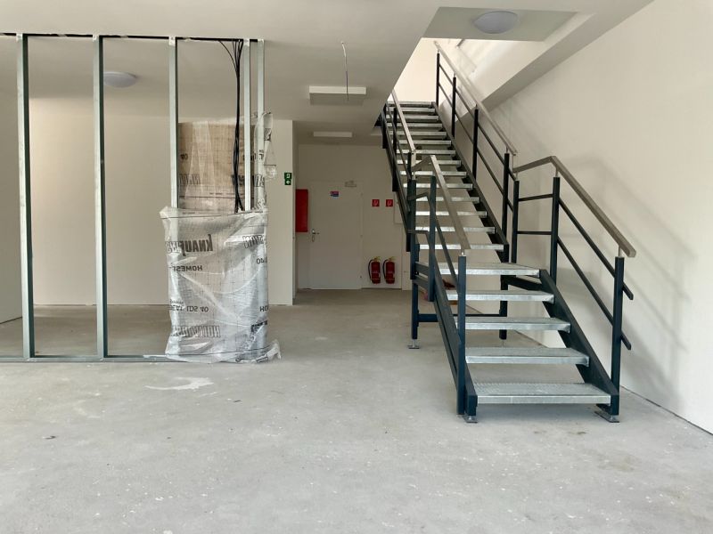 Interior with staircase in warehouses and halls with metal railing and beam.