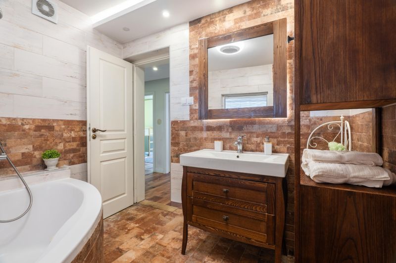 A bathroom with stylish tiles and wooden furniture in a 4-room apartment.