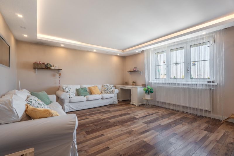 Living room in a 4-room apartment with a light sofa, wood-patterned flooring, and decorative lighting.