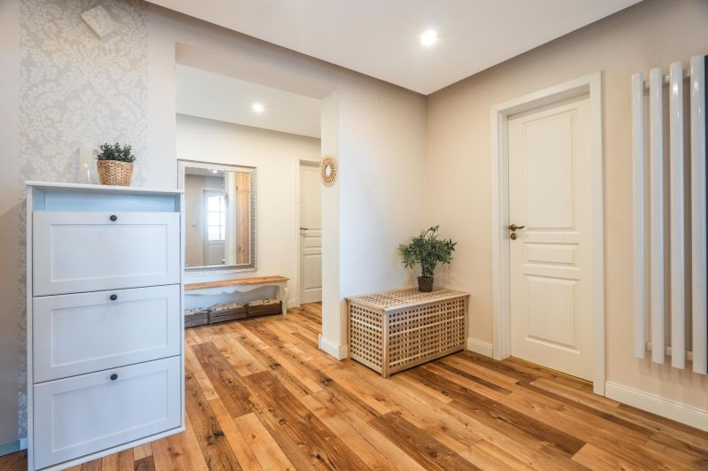 Interior of a 4-room apartment with a wooden decor floor, a dresser, and a mirror.