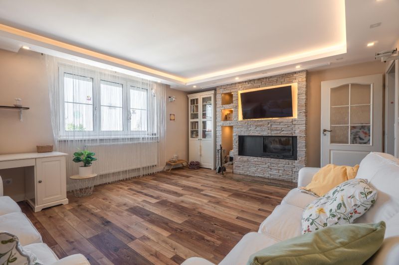 Living room in a 4-room apartment with a fireplace, wooden decor flooring, and comfortable seating.