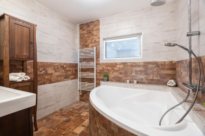 A bathroom in a 4-room apartment with a corner bathtub and brick tile cladding.