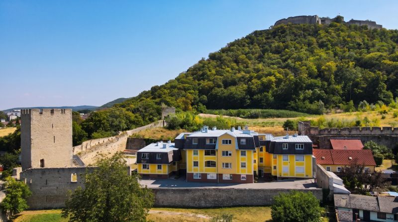 Yellow buildings on Babenbergerstraße in Hainburg an der Donau with historic fortifications.