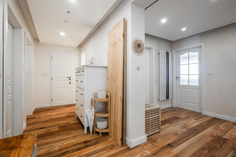 A hallway in a 4-room apartment with a wooden decor floor and storage spaces.