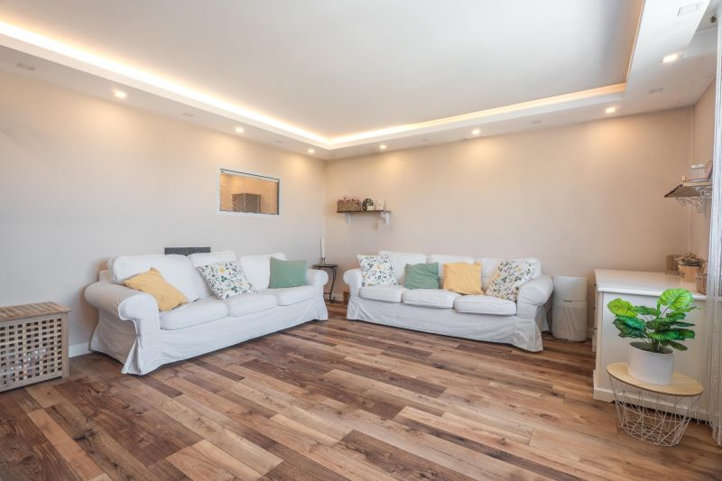 Living room in a 4-room apartment with white sofas and a floor with a wooden decor.