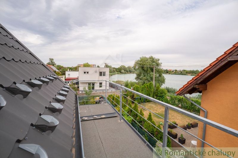 View from the Cottage in Senec of the lake and the gardens of the houses.