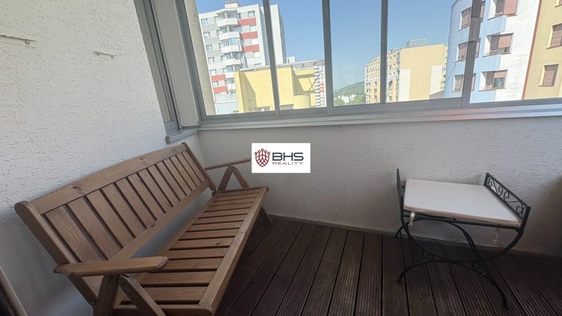 A furnished balcony with doors from a 2-room apartment overlooking Kresánkova Street.