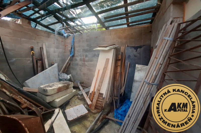 Building materials in an unfinished room of a family house with a roof structure.