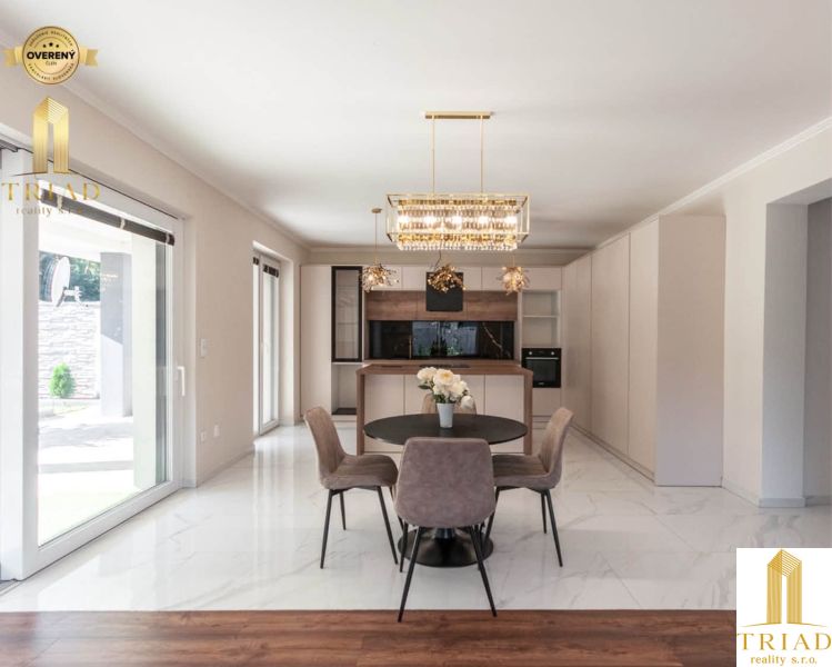 Family house with a dining area, kitchen, and wooden decor flooring.