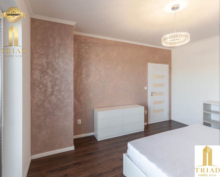 Interior of a family house with a wooden decor floor, white furniture, and a decorative wall.