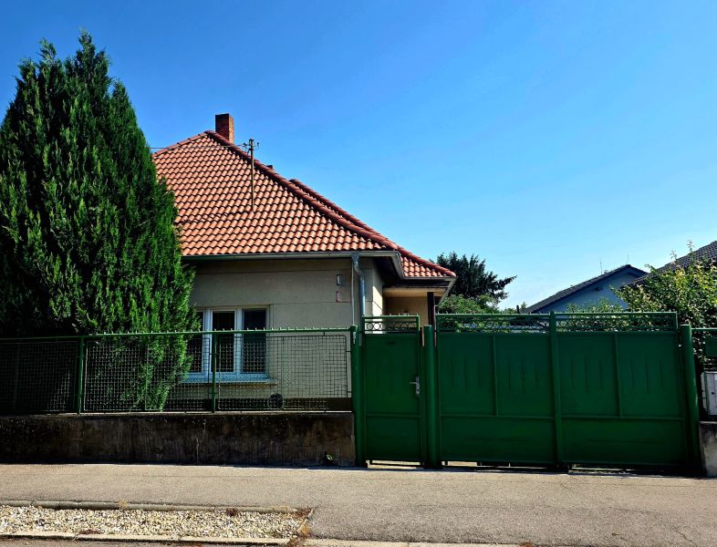 A family house on Murgašova Street in Šaľa with a red roof and a green gate.