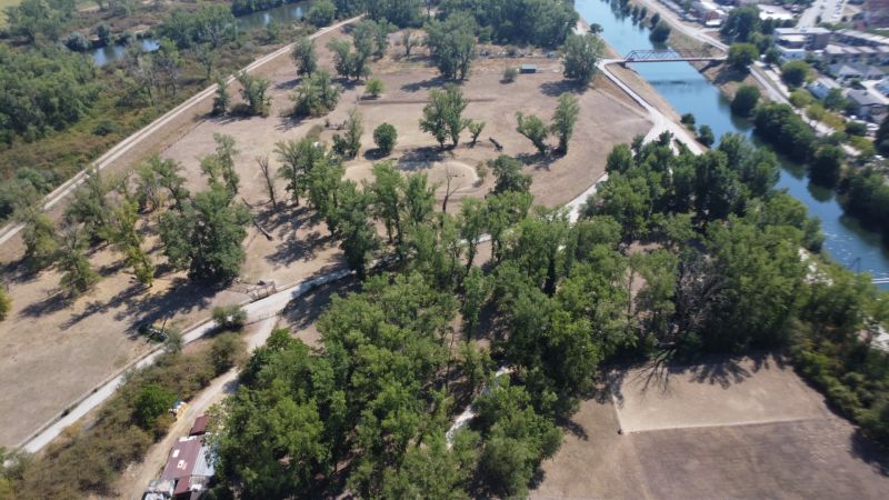 Aerial view of Recreational plots in Piešťany with wooded areas and a river.