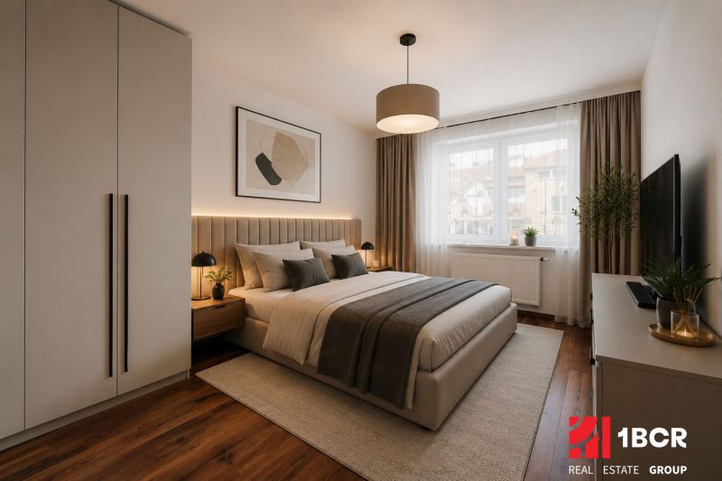 A stylish bedroom in a two-room apartment with a wooden decor floor and elegant furnishings.