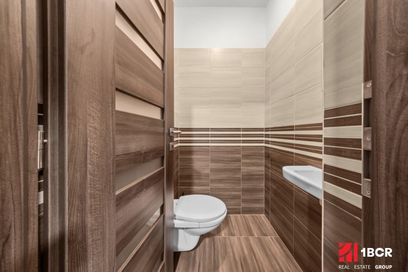 Bathroom with wood-patterned flooring and ceramic tiles, 2-room apartment.