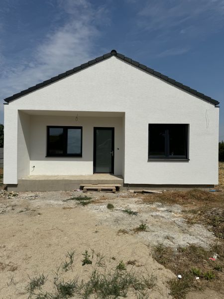 A family house in Suchá nad Parnou with a sloping roof and a light facade.