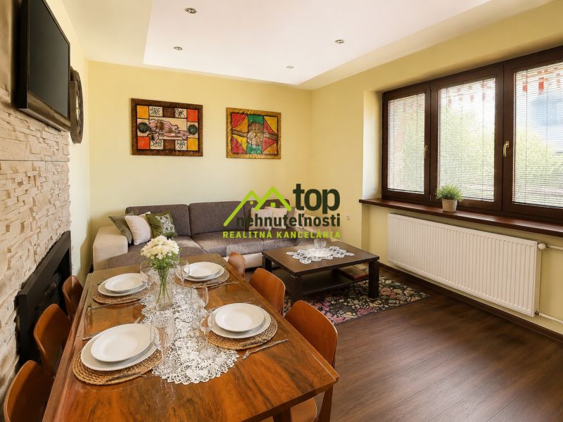 Living room in a family house with a dining table and wooden decor flooring.