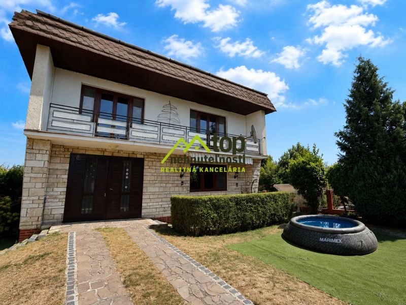 A family house in Topoľčany on Ľaliová Street with a swimming pool in the garden.