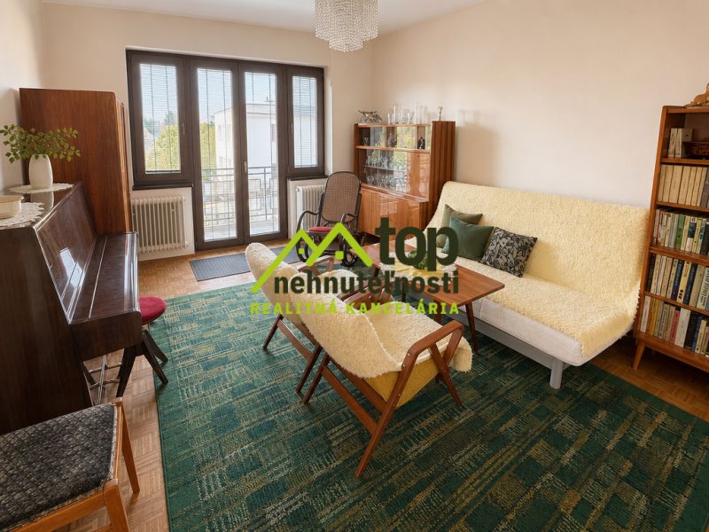 Living room in a family house with furniture, a piano, and a bookshelf, floor with wooden decor.