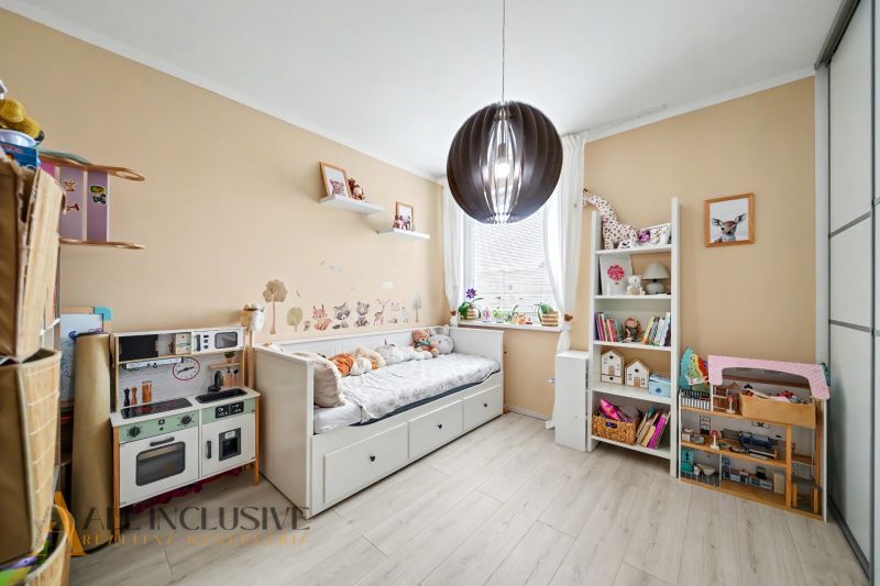Children's room with creative decorations and furniture on a floor with wooden decor.