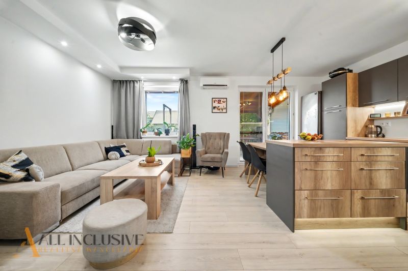 Living room with a kitchenette in a 3-room apartment, floor with wooden decor.