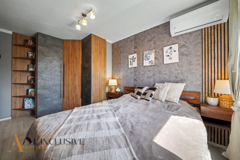 Bedroom in a 3-room apartment with a wood-patterned floor and air conditioning.