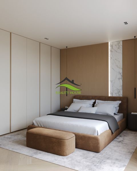 A bedroom with a wood-patterned floor in a 3-room apartment, simple design and a bed.