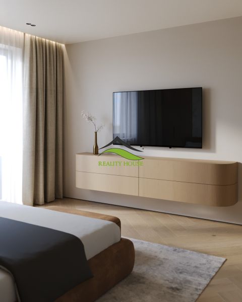 Bedroom in a 3-room apartment with a TV and a floor with a wood decor.
