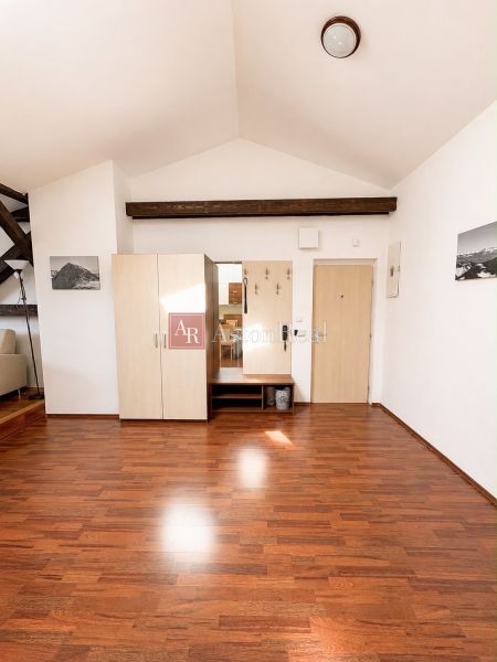 Interior with wood-patterned flooring and a wardrobe in a 3-room apartment.