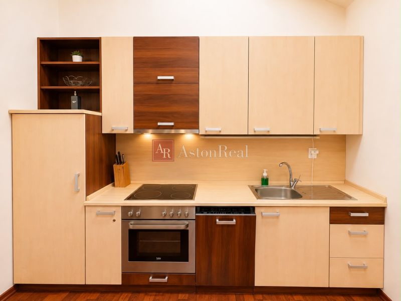 A kitchen in a 3-room apartment with a wooden decor floor, light furniture.