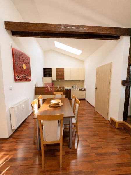 Interior of a 3-room apartment with a dining table, meadow light, and a floor with a wooden decor.