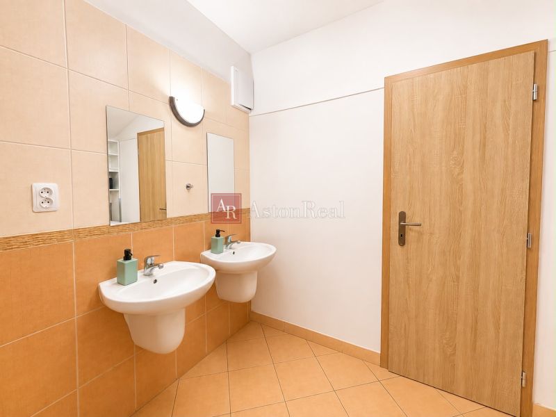 A bathroom with two sinks and floor tiles in a 3-room apartment.