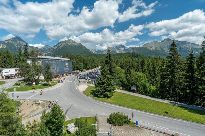 A recreational apartment in Poprad offers views of the mountains, forests, and a parking lot.
