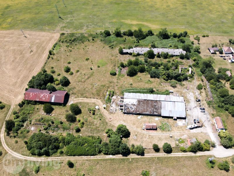 Fields and abandoned buildings surrounded by greenery in Stará Turá. Unusual properties.