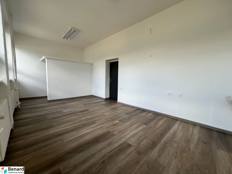 Offices with wood-patterned flooring, light-colored walls, simple design.