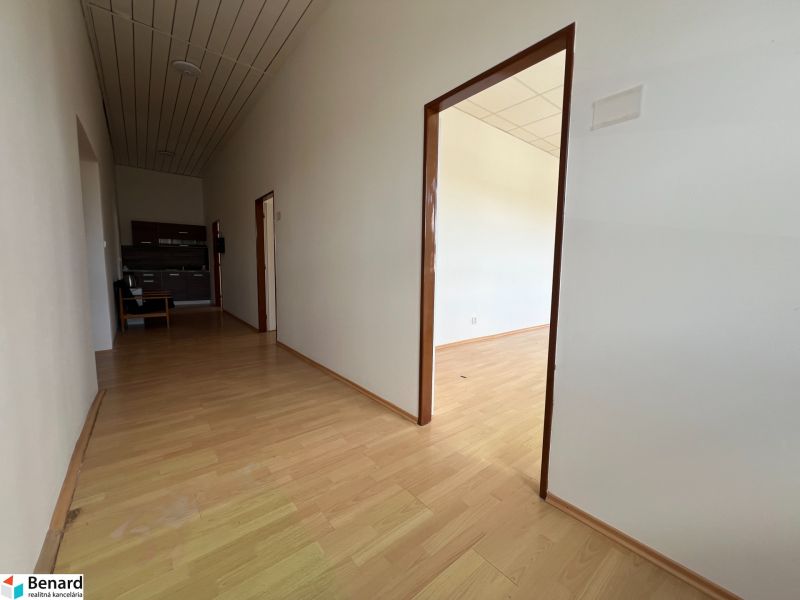 Offices with wood-patterned flooring and a kitchenette.