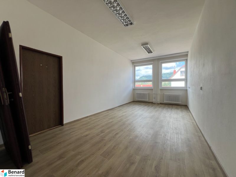 Offices with a bright interior and wood-decor flooring, equipped with large windows.