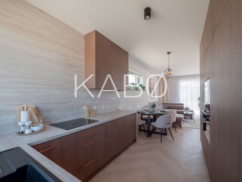 Kitchen and living room in a family house with a wooden decor floor.
