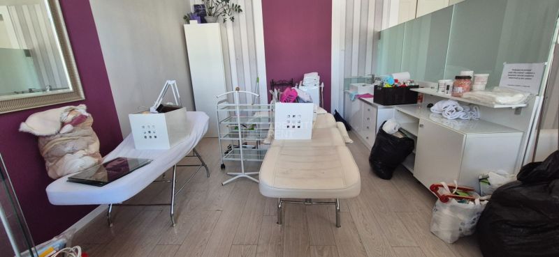 Offices with desks, a mirror, and a floor with a wood decor, white-purple walls.